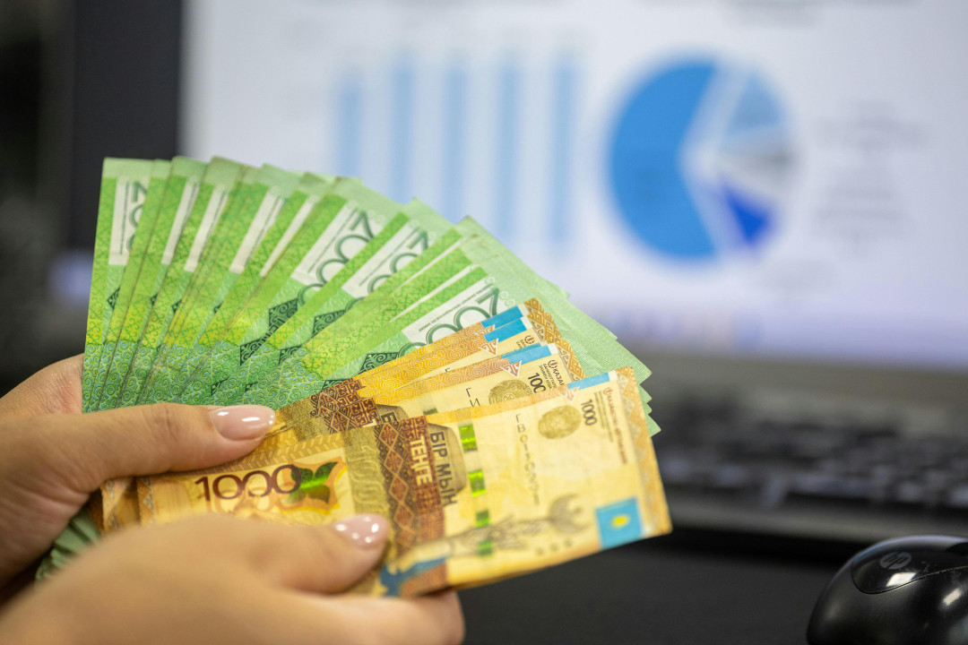 kazakhstan-tenge-money-in-hand-business-concept-image