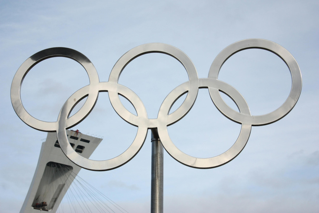 olympic-rings-on-tower-against-blue-sky-image