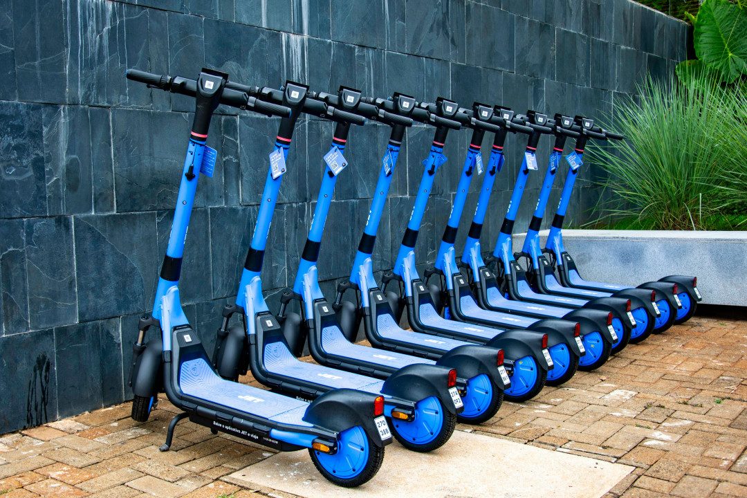 group-of-electric-scooters-neatly-arranged-outdoors-ready-for-rent-image