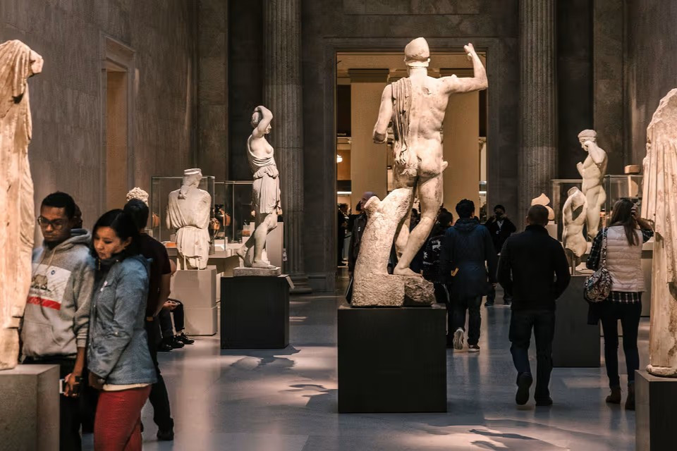 greek-sculptures-in-museum-gallery-with-visitors-image