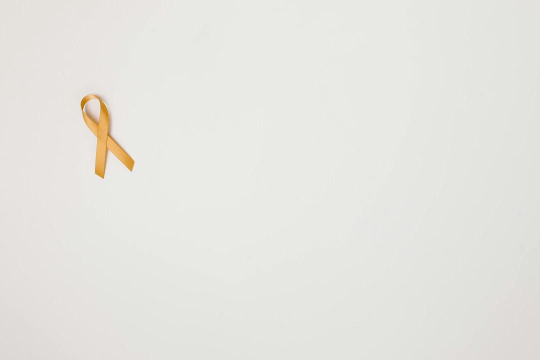 yellow-awareness-ribbon-on-white-background-childhood-cancer-support-image