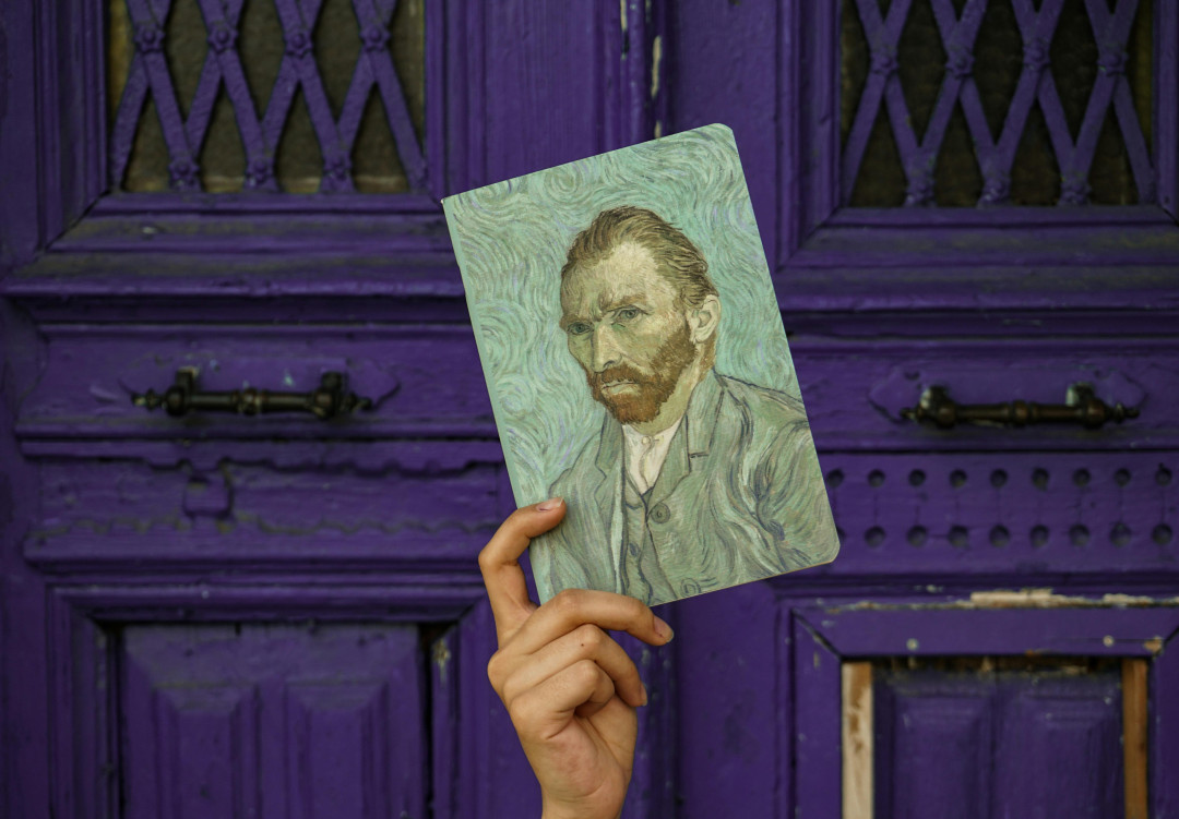 hand-holding-notebook-with-van-gogh-painting-image