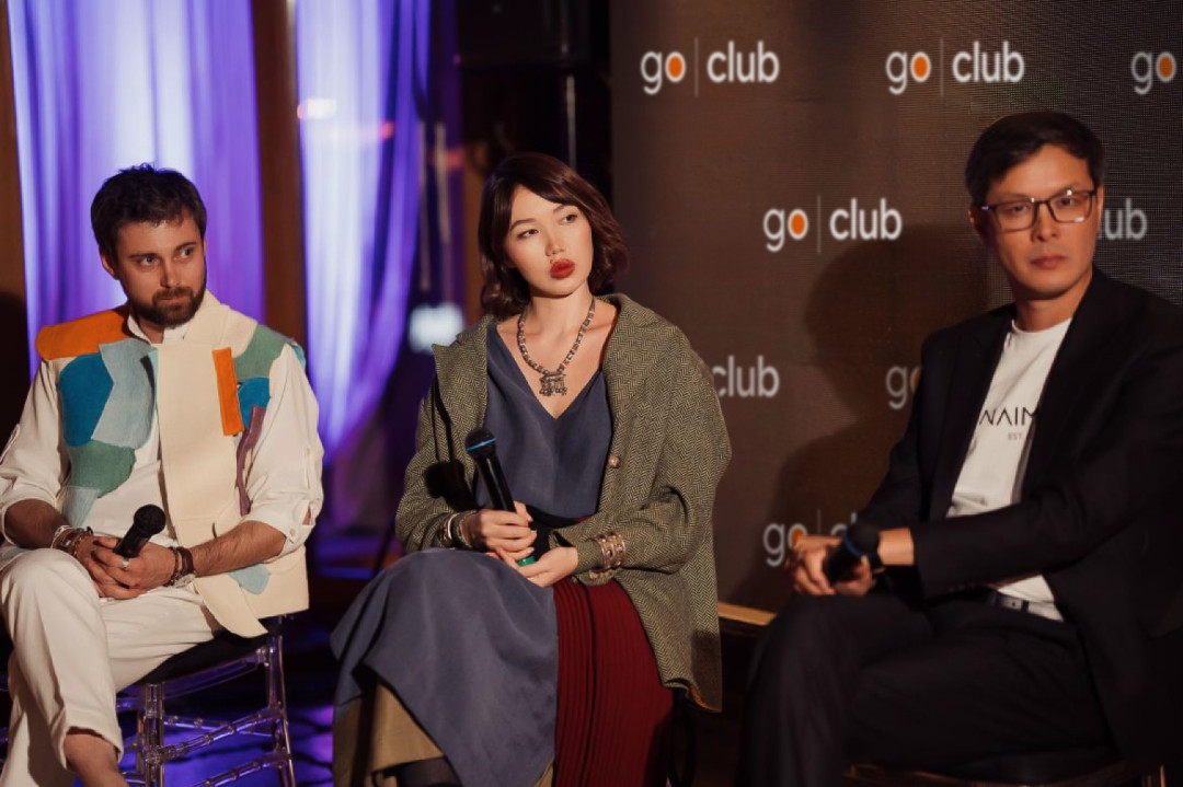 panel-discussion-at-go-club-event-with-speakers-holding-microphones-image