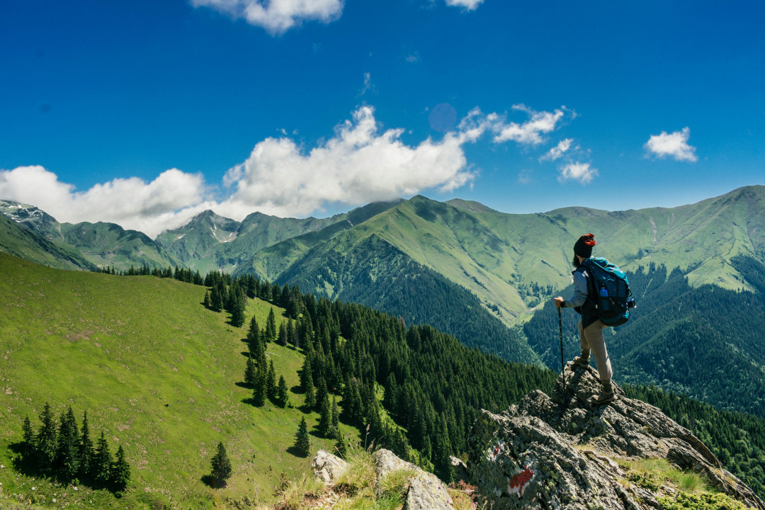 traveler-standing-looking-at-mountains-backpack-hiking-adventure-image