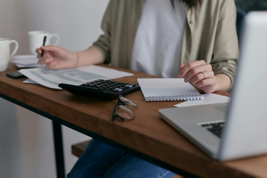 person-sitting-on-desk-in-office-writing-on-paper-image