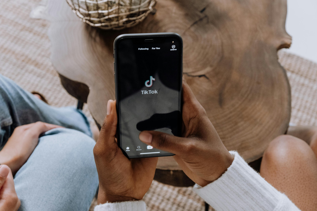 person-holding-smartphone-with-tiktok-app-open