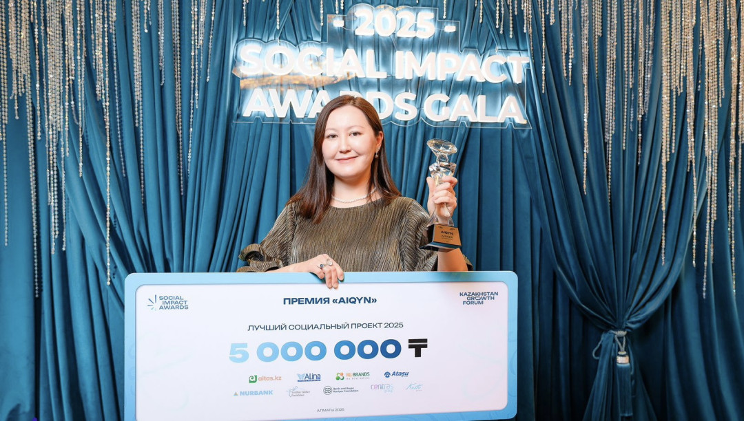 social-impact-awards-2025-winner-holding-trophy-and-certificate-image