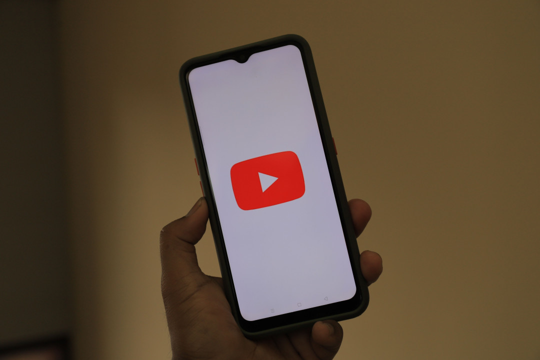 human-hand-holding-smartphone-with-youtube-on-screen-image