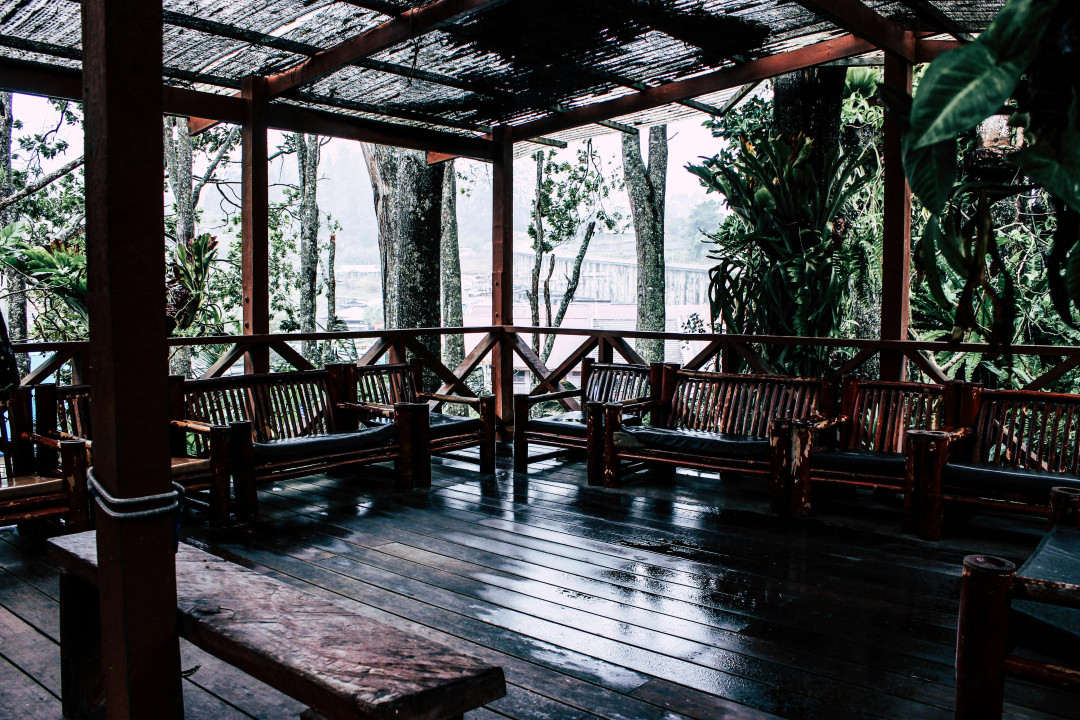 brown-wooden-tropical-cottage-with-veranda-and-greenery-in-Malaysia-image