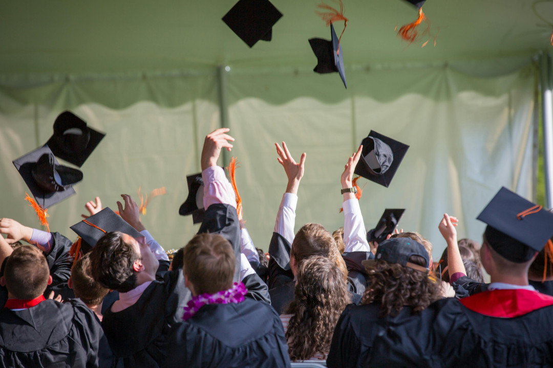 university-graduates-celebrating-throwing-caps-in-the-air-image