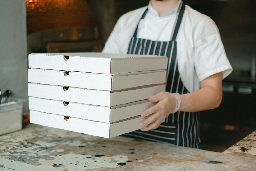 man-holding-several-pizza-boxes-image